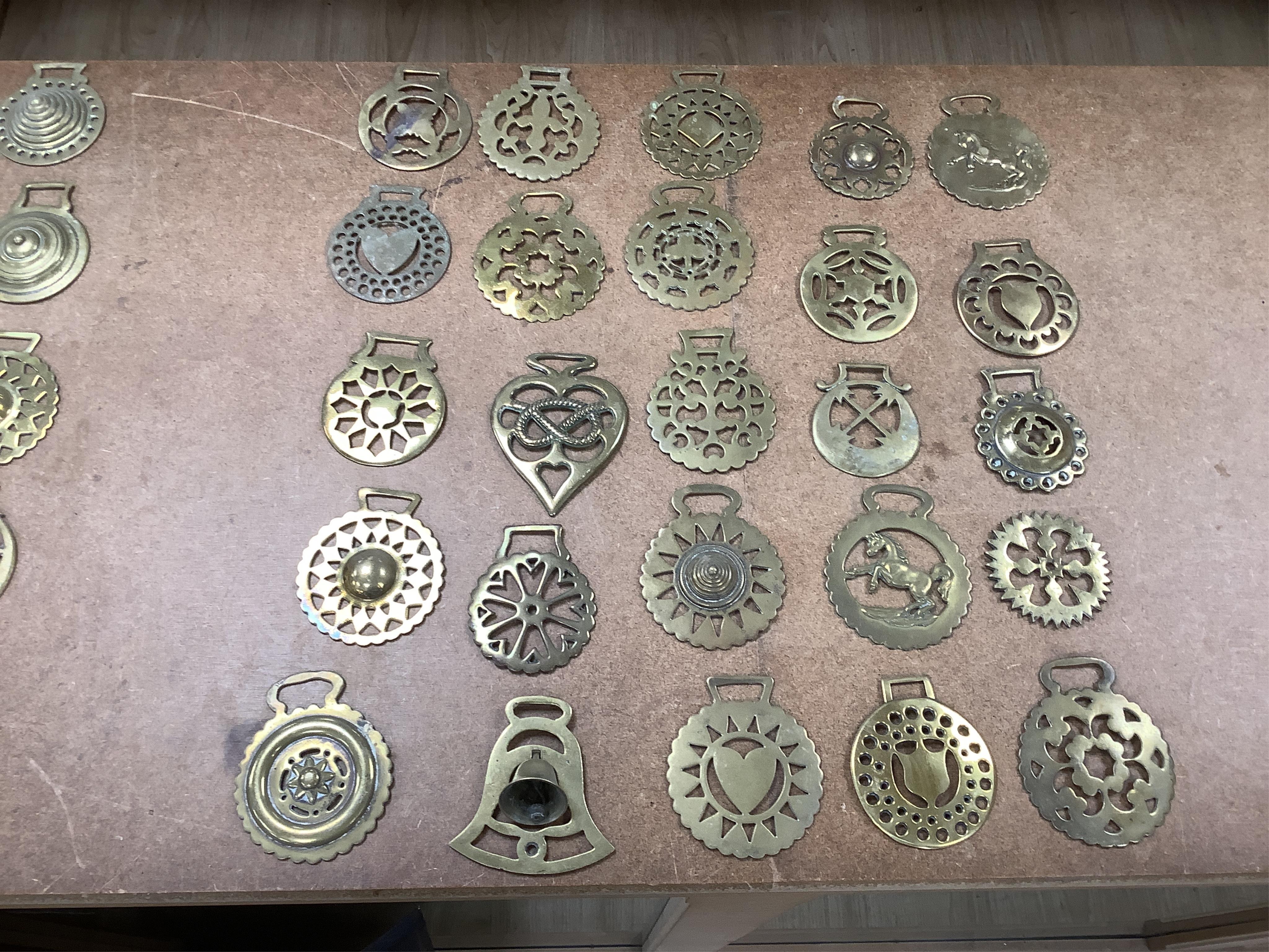 A collection of various horse brasses